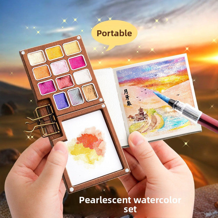 Pearlescent solid watercolour paint set open on a desk