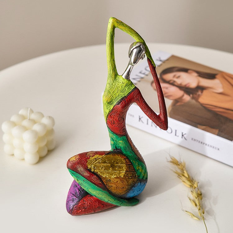 Stylised figure sculpture in cast resin on a shelf