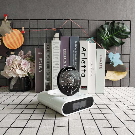 Alarm clock with an infrared target and toy gun