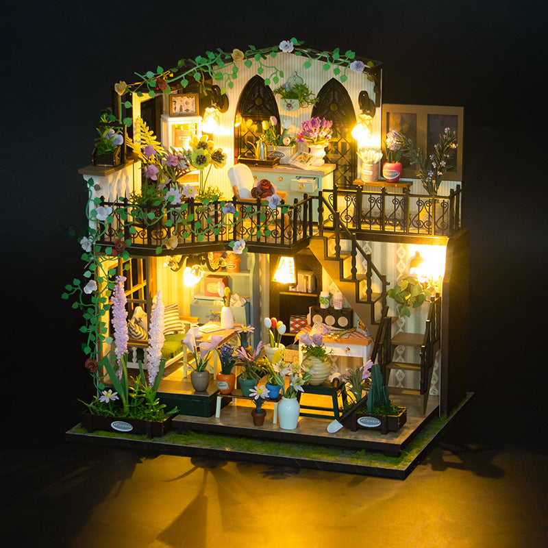 Two-storey wooden villa model with a garden at the front