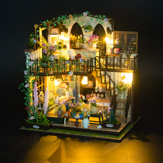Two-storey wooden villa model with a garden at the front