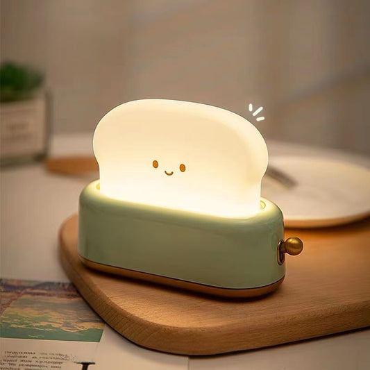 Cartoon bread machine night light glowing warm on a nightstand