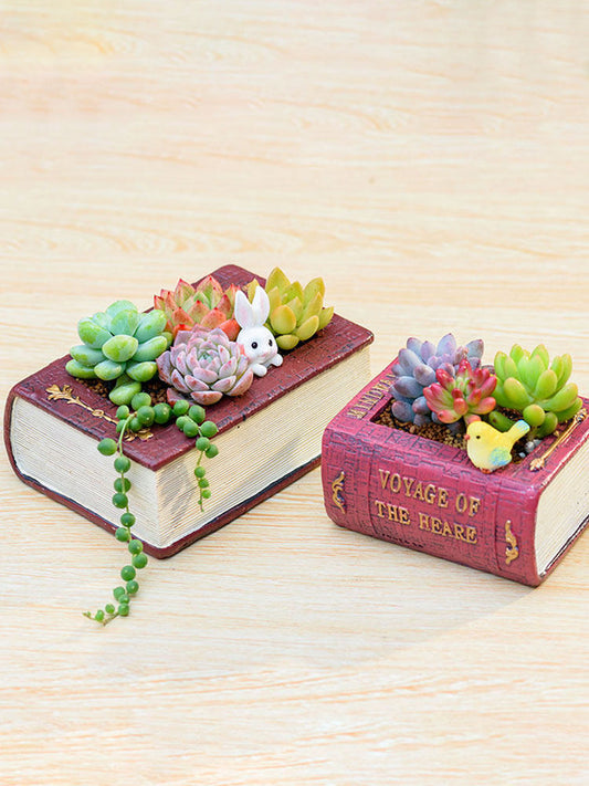 Cast resin planter shaped like a stack of old books