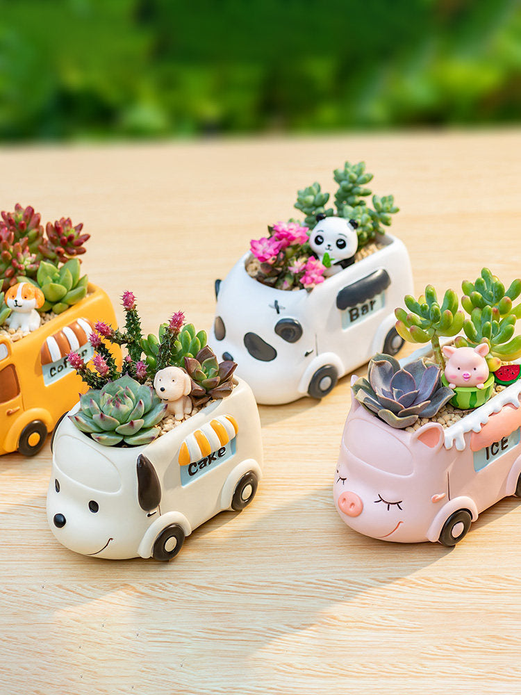 Small resin planters shaped like carts, with animal figures